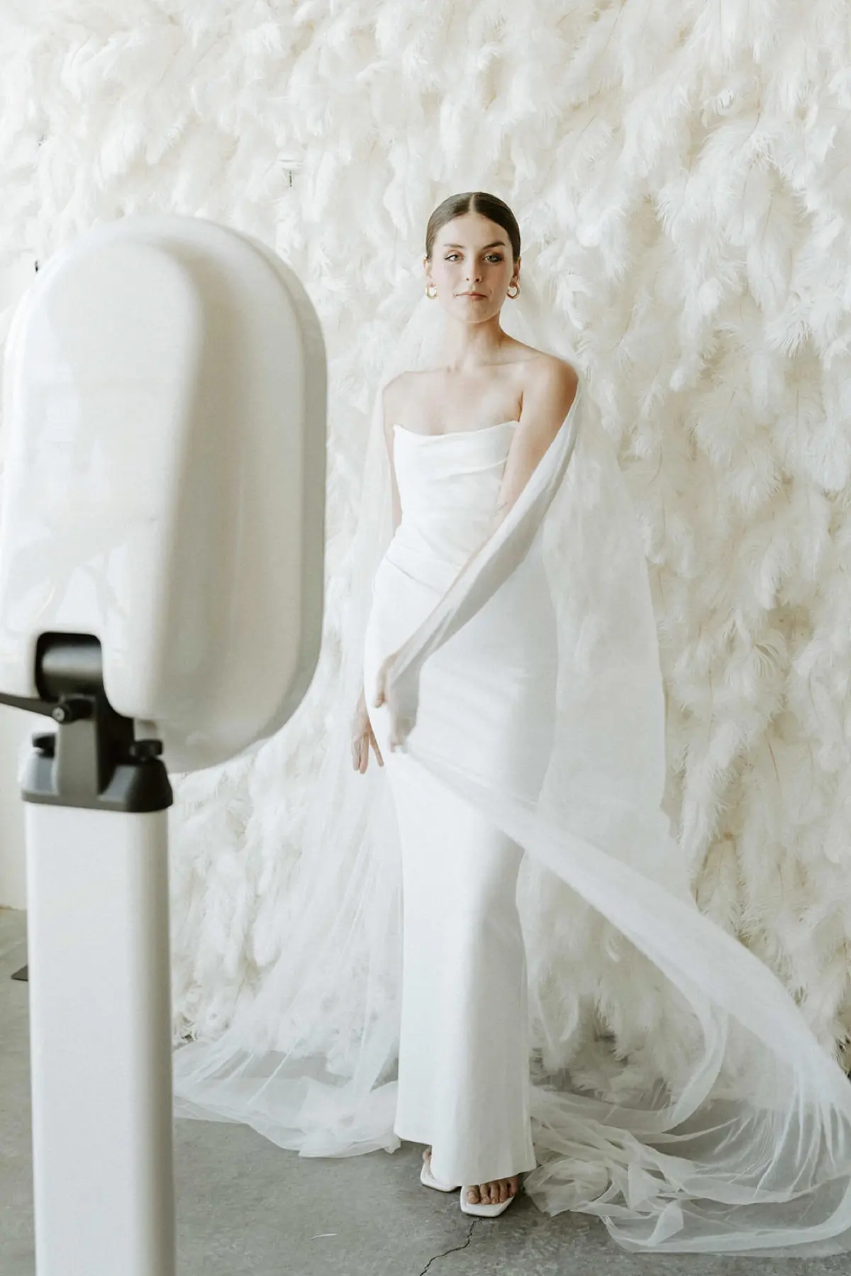 Feather and flower wall photo booth rental at Los Angeles celebration